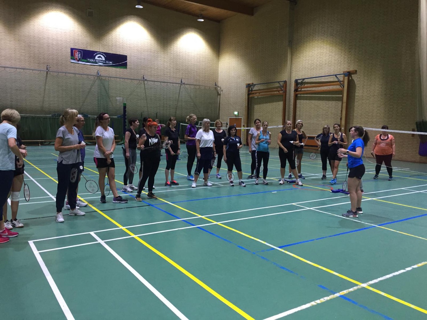 Kirsty Wilcox coaching a large ladies-only group on court